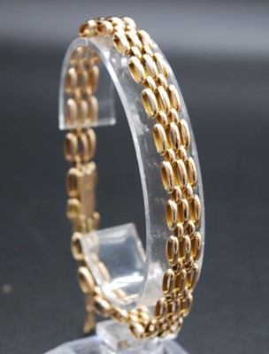 Lot 2680 - A 15ct gold gatelink bracelet, with safety...