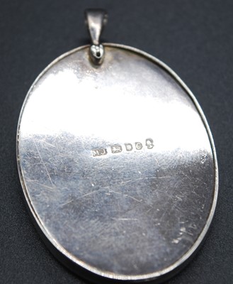Lot 2689 - A modern Arts & Crafts silver pendant, having...