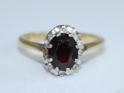 Lot 2727 - A yellow metal, garnet and diamond oval...