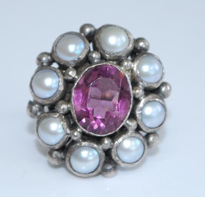 Lot 2735 - A white metal, garnet and pearl oval cluster...