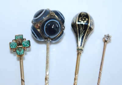 Lot 2743 - Four assorted stick pins, being a yellow metal...