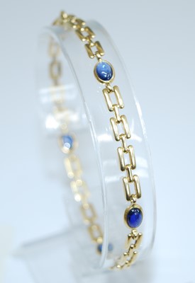 Lot 2745 - A yellow metal sapphire bracelet, comprising...