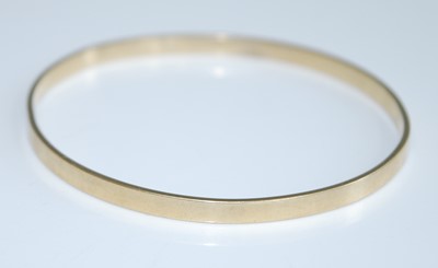 Lot 2746 - A modern 9ct gold bangle, undecorated, sponsor...