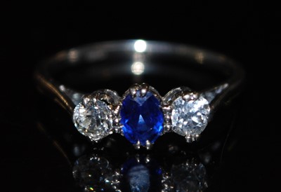 Lot 2761 - A platinum sapphire and diamond three stone...