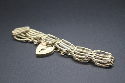 Lot 2771 - A 9ct gold gatelink bracelet with heart shaped...