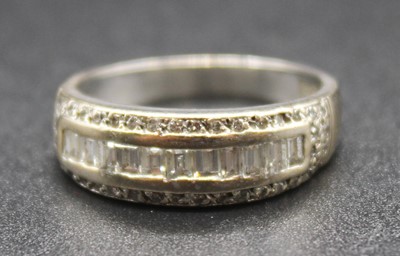 Lot 2803 - An 18ct white gold and diamond set half hoop...