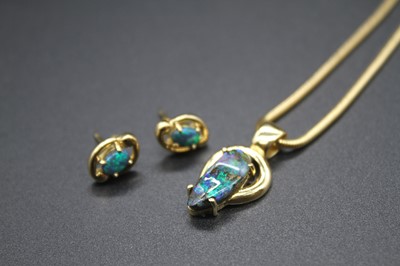 Lot 2825 - A modern yellow metal opal set pendant, the...