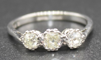 Lot 2808 - A white metal diamond three-stone ring...