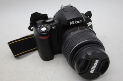 Lot 385 - A Nikon D40X SLR camera, with three Nikon zoom...
