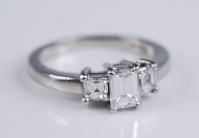 Lot 2204 - A platinum diamond three stone ring, featuring...