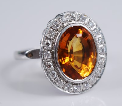 Lot 2207 - A platinum citrine and diamond oval cluster...