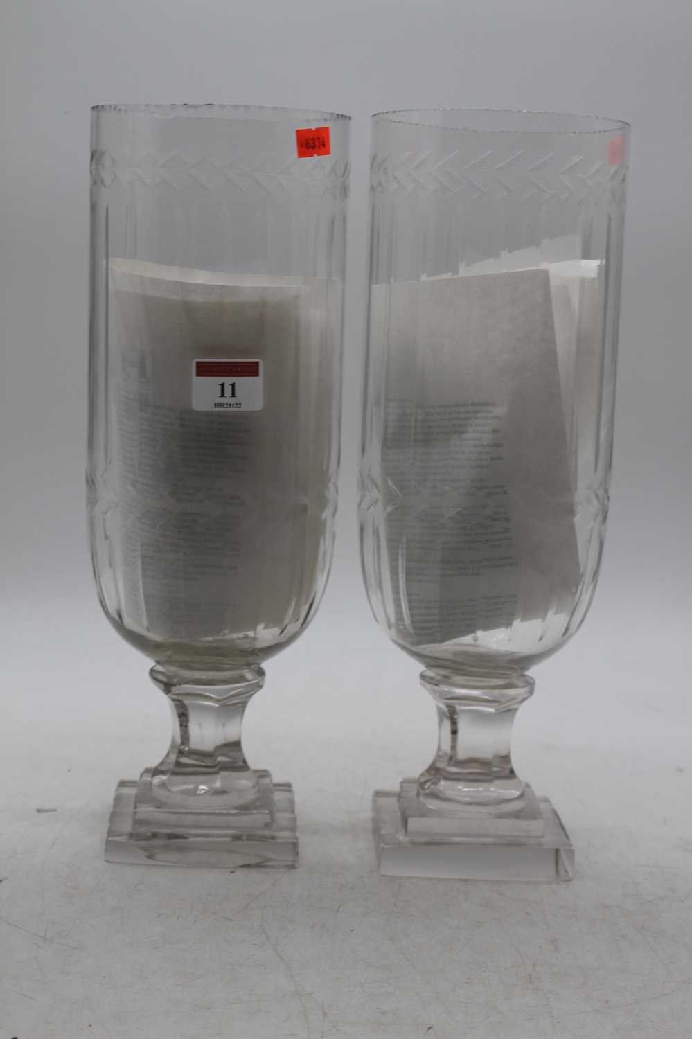 Lot 11 - A pair of modern glass storm lamps having an...