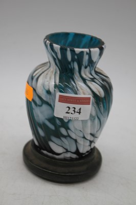 Lot 234 - A blue and white glass vase, mounted upon a...