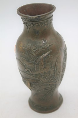 Lot 237 - A Japanese Meiji period metal vase, relief...