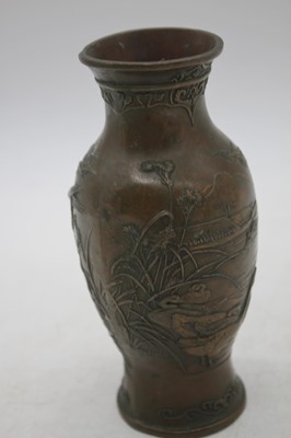 Lot 237 - A Japanese Meiji period metal vase, relief...
