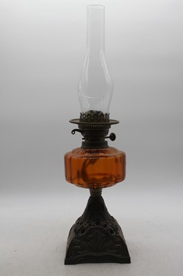 Lot 144 - A late Victorian oil lamp having an amber...