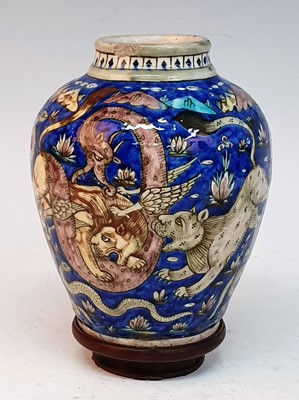 Lot 2423 - A 19th century Persian Qajar earthenware vase,...