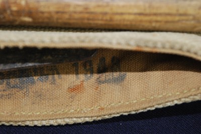 Lot 115 - A WW II entrenching tool, in webbing pouch,...