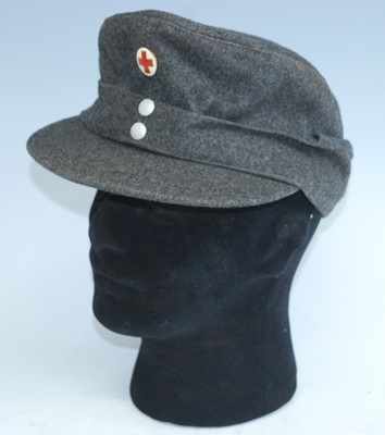 Lot 85 - A post WW II German M43 grey woolen field cap,...