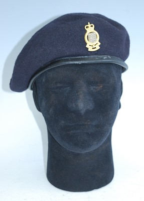 Lot 217 - A blue woollen beret with badge for the Army...