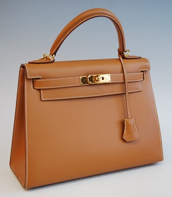 Lot 2394 - An Hermès tan leather Kelly bag, with gilt...