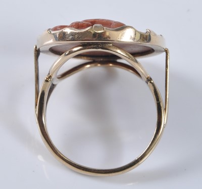 Lot 2182 - A yellow metal oval lava stone cameo ring,...