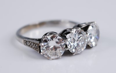 Lot 2237 - A white metal diamond three stone ring,...