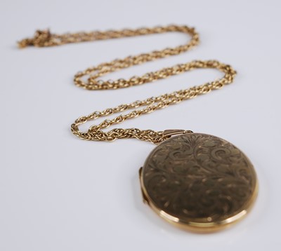 Lot 2255 - A 9ct yellow gold oval locket, engraved with...