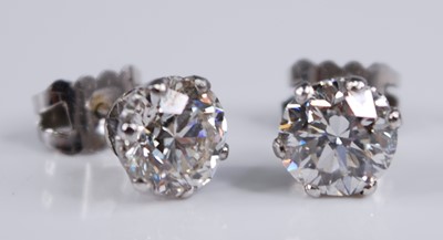 Lot 2258 - A pair of white metal diamond stud earrings,...