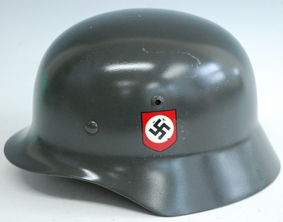 Lot 167 - A reproduction German M 1935 steel helmet with...
