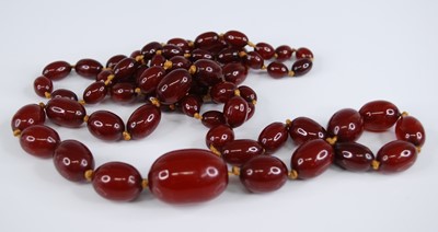 Lot 2321 - A cherry amber necklace, the 66 graduated...