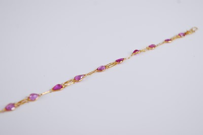 Lot 2284 - A contemporary yellow metal and pink sapphire...