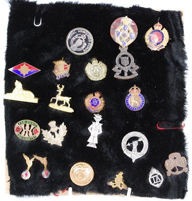 Lot 170 - A collection of military and related badges,...