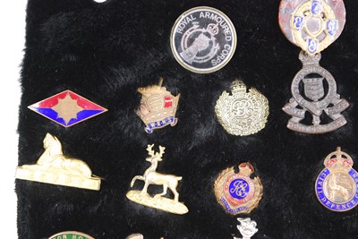 Lot 170 - A collection of military and related badges,...