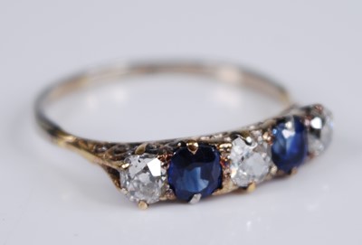 Lot 2272 - A yellow metal, sapphire and diamond half hoop...