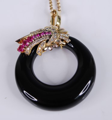 Lot 2225 - A yellow metal onyx, ruby and diamond pendant,...