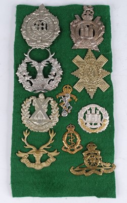 Lot 308 - A small collection of cap and collar badges,...