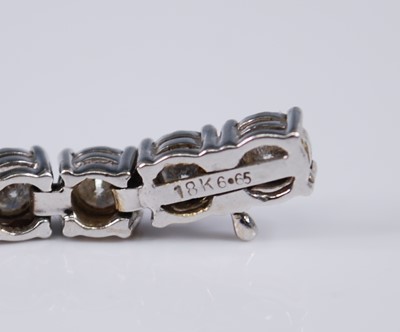 Lot 2199 - An 18ct white gold diamond set tennis bracelet,...
