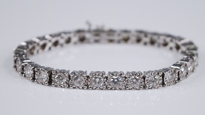 Lot 2199 - An 18ct white gold diamond set tennis bracelet,...