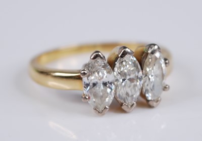 Lot 2297 - A yellow metal diamond three stone ring, the...