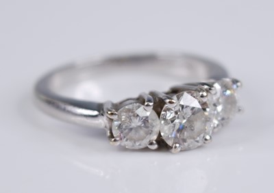 Lot 2300 - An 18ct white gold diamond three stone ring,...