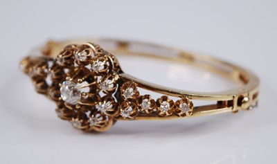 Lot 2200 - A yellow metal diamond set hinged bangle, the...