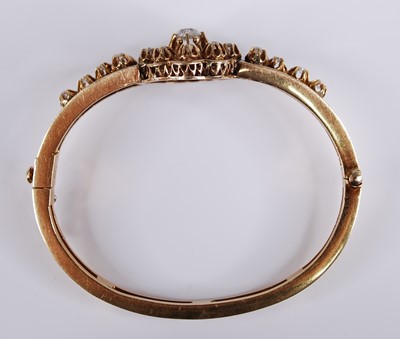 Lot 2200 - A yellow metal diamond set hinged bangle, the...