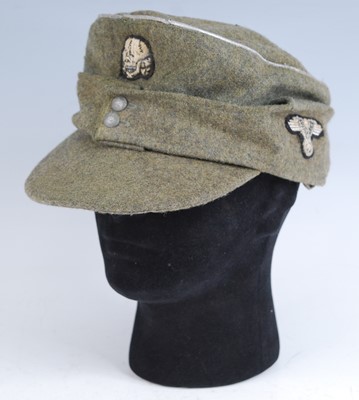 Lot 295 - A German M43 Field cap, in green with silver...