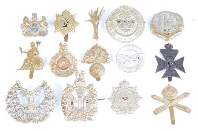 Lot 702 - A collection of cap badges and insignia to...