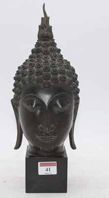 Lot 41 - A bronze buddha head, mounted upon a polished...