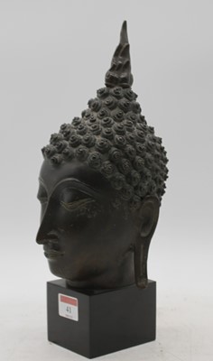 Lot 41 - A bronze buddha head, mounted upon a polished...