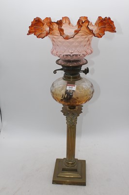 Lot 142 - A Victorian brass oil lamp, the amber tinted...