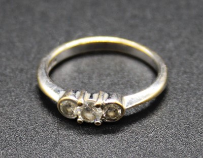 Lot 395 - A 9ct white gold diamond three stone ring,...