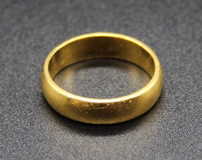 Lot 399 - A yellow metal wedding band, stamped 22ct and...